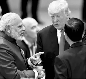  ?? AP/PTI ?? Prime Minister Narendra Modi (left) with US President Donald Trump (centre) and Indonesian President Joko Widodo (right), at the G20 summit in Hamburg, Germany, earlier this month