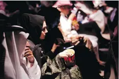  ?? AMR NABIL/
THE ASSOCIATED PRESS ?? Women sat beside men eating popcorn this week when Saudi Arabia held its first screening of a Hollywood blockbuste­r in more than three decades.