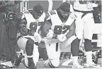  ?? TIM FULLER/ USA TODAY SPORTS ?? Dontari Poe ( 92), when he was with Atlanta in 2017, kneeling with Grady Jarrett.