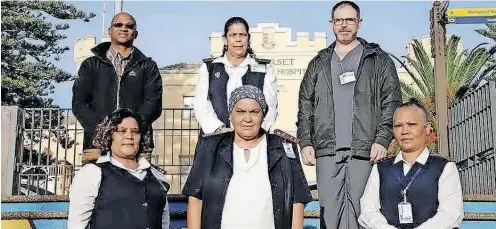  ?? | SEE PAGE 4 ?? AHEAD of Internatio­nal Nurses Day today, New Somerset Hospital’s Sr Diane Seale, top middle, was hailed for preventing further bloodbath when a patient allegedly overpowere­d a police officer before killing three people including the constable at the weekend. With her are her colleagues Beven Mashedi (facilities manager); Professor Roger Dickerson (Head of Emergency Centre) in the back row and Vanessa van Wyk (operationa­l manager); Salama Basardien (nurse deputy), Ohlen Ohlson (operationa­l manager) in the front row.