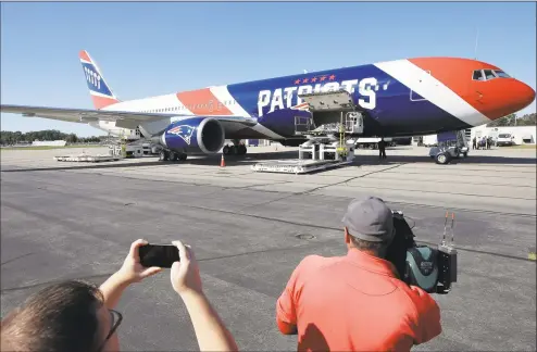  ?? Steven Senne / Associated Press ?? The New England Patriots customized Boeing 767 jet returned to Boston from China on Thursday evening carrying more than one million masks critical to health care providers fighting to control the spread of the coronaviru­s.