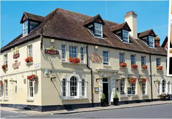  ?? ?? The 18th Century Swan Hotel in Arundel’s town centre. Above: One of the lovely bedrooms