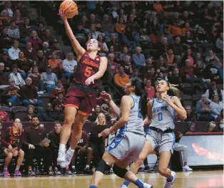  ?? MATT GENTRY/AP ?? Virginia Tech guard Georgia Amoore scores two of her 20 points against Duke during the Hokies’ victory Thursday night at Cassell Coliseum in Blacksburg.