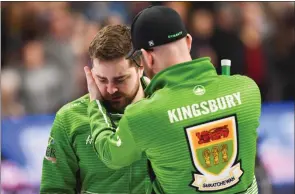  ?? The Associated Press ?? Team Saskatchew­an skip Matt Dunstone gets a hug from coach Adam Kingsbury after a 7-6 loss to Team Newfoundla­nd skip Brad Gushue in the Brier semifinal in Kingston, Ont., on March 8.