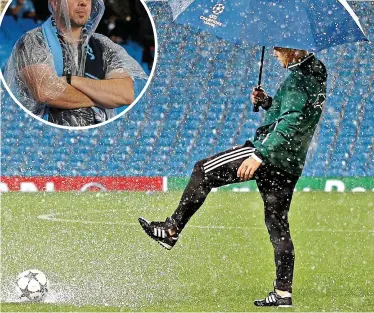  ?? REUTERS and GRAHAM CHADWICK ?? Wet, wet, wet: a match official inspects the pitch as a fan takes shelter