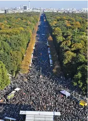  ?? (AFP) ?? Demonstrat­ors gather between the Brandenbur­g Gate and the Victory Column during a march organised by the group ‘Unteilbar’, in Berlin’s Tiergarten district on Saturday