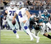  ?? AP/MICHAEL AINSWORTH ?? is sacked by Derek Barnett of the Philadelph­ia Eagles during the Cowboys’ 37-9 loss Sunday night. A year after winning a franchise-record 11 consecutiv­e games, Dallas (5-5) is trying to stay in playoff contention.