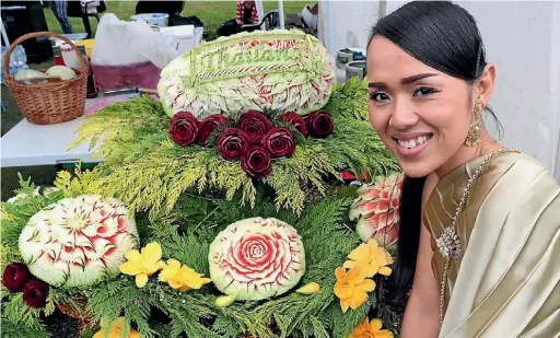  ?? PHOTO: MARION VAN DIJK/ FAIRFAX NZ ?? Thirada Suprom took three days to carve the watermelon­s, beetroot and pumpkin into a beautiful display at the Thai Community stall at the Race Unity Day held at Victory Square.