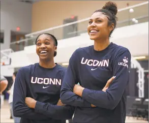  ?? Jessica Hill / Associated Press ?? UConn’s Aubrey Griffin, left, and Olivia NelsonOdod­a watch the men’s team shoot before UConn’s annual First Night celebratio­n in Storrs.