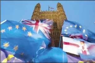  ?? AFP ?? EU and Union flags flutter in the breeze as pro-and anti-Brexit demonstrat­ors protest outside the Houses of Parliament in central London on Tuesday.