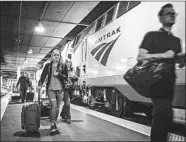  ?? BRIAN CASSELLA/CHICAGO TRIBUNE ?? Passengers board an Amtrak Empire Builder train in 2017 at Chicago’s Union Station.