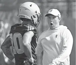  ?? PATRICK BREEN/THE REPUBLIC ?? ASU head coach Kenny Dillingham talks with wide receiver Giovanni Sanders (20) during a spring practice at the Kajikawa practice fields.