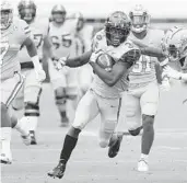  ?? STEPHEN M. DOWELL/ORLANDO SENTINEL ?? UCF running back Greg McCrae runs away from Tulane on Saturday at the Bounce House in Orlando.