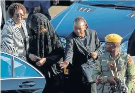  ?? /Reuters ?? Widow: Grace Mugabe, left, at the airport in Harare. The body of her husband, former Zimbabwean president Robert Mugabe, was flown in on Wednesday.