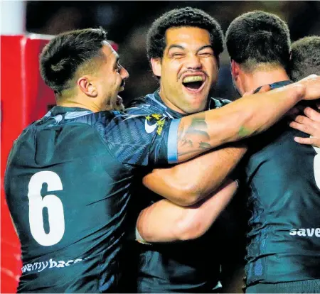  ??  ?? Jesse Bromwich celebrates his try with Kenny Bromwich, Adam Blair and Shaun Johnson in Leeds yesterday.