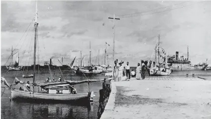  ?? Picture: AFP ?? MAYBE. This photo released by the US National Archives shows a group of people on a dock on the Jaluit Atoll, Marshall islands, one of whom looks like aviator Amelia Earhart.