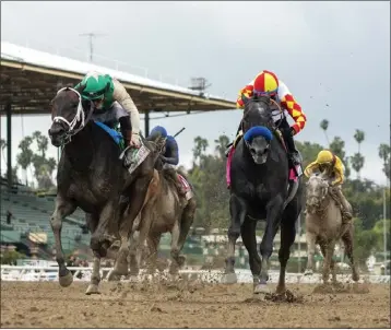  ?? BENOIT PHOTO VIA AP ?? A Mo Reay and jockey Flavien Prat, left, win the Grade I $500,000 Beholder Mile on Saturday at Santa Anita Park.