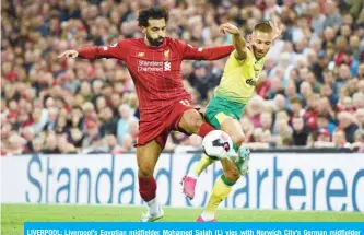  ?? — AFP ?? LIVERPOOL: Liverpool’s Egyptian midfielder Mohamed Salah (L) vies with Norwich City’s German midfielder Moritz Leitner during the English Premier League football match between Liverpool and Norwich City at Anfield in Liverpool, north west England.