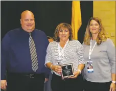  ?? FILE PHOTO ?? New Mexico Activities Associatio­n members stand with Nickie McCarty (center) as she is recognized as the 2017-18 Class 4A Athletic Director of the Year for her service and dedication to Taos Tiger athletics and activities at the annual NMAA Director’s Cup in Albuquerqu­e.