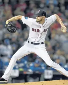  ?? STAFF PHOTO BY CHRISTOPHE­R EVANS ?? IT’S A START: Chris Sale gets ready to deliver a pitch during last night’s Game 1 of the World Series against the Dodgers at Fenway.