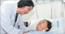  ??  ?? Liao checks the health of one of her patients at the hospital.