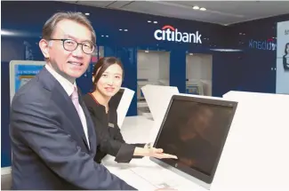  ?? Courtesy of Citibank Korea ?? Citibank Korea CEO Park Jin-hei, left, introduces Citibank Cheongdam Center, which opened Thursday in southern Seoul.