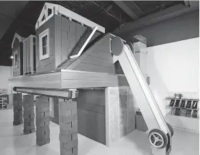  ?? SUPPLIED PHOTOS ?? The Saskatchew­an Science Centre’s home-building exhibit allows visitors to apply shingles to the roof, stack bricks on columns at the front of the house, apply siding, or use a child-powered conveyor belt to take the shingles to the roof.