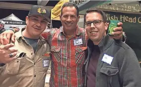  ?? PATRICK JANSEN PHOTO. ?? Chris Roberts (left) and Patrick Jansen (right) were among the many people getting selfies with Sam Calagione, co-founder of Dogfish Head Brewery, at a recent trade show in Milwaukee.