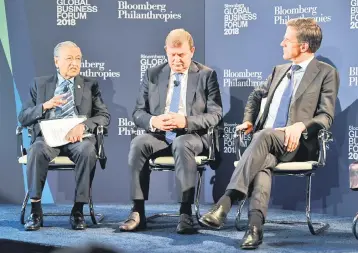  ??  ?? Dr Mahathir (left) speaks during his panel session at the Bloomberg Global Business Forum which was part of his five-day working visit to London earlier this week. — Bernama photo