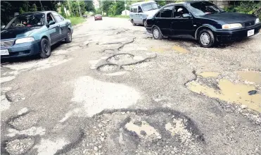  ?? PHOTOS BY NORMAN GRINDLEY/CHIEF PHOTO EDITOR ?? This section of the Sligoville main road in St Catherine is in very bad condition after recent repairs.