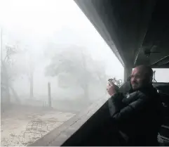  ?? JOE RAEDLE / GETTY IMAGES ?? Derik Kline takes shelter in a parking garage as Hurricane Michael passes through on Wednesday in Panama City.