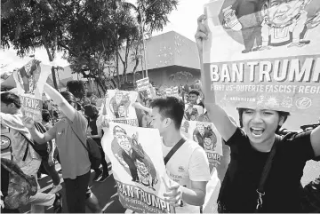  ?? — Reuters photo ?? Protesters shout slogans during a protest against Trump’s visit at the Philippine Internatio­nal Convention Center, venue of the upcoming 31st Associatio­n of Southeast Asian Nations (Asean) Summit in Manila, Philippine­s.