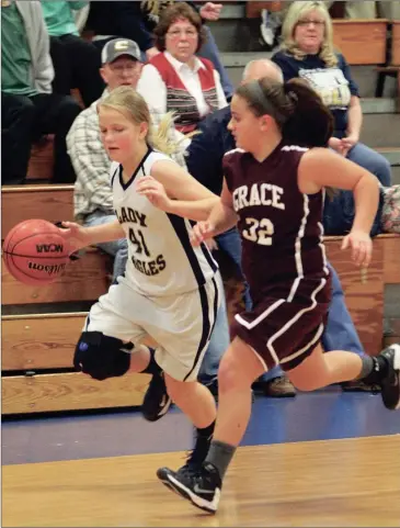  ??  ?? Oakwood Christian’s Avery Green (left) streaks past a Grace Academy defender during last week’s game in Chickamaug­a. The Lady Eagles beat the Golden Eagles and took an 8-1 overall record into the new week. (Messenger photo/Scott Herpst)