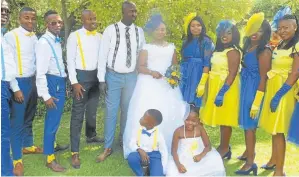  ??  ?? Tebogo and Valentine flanked by groomsmen and bridesmaid­s.