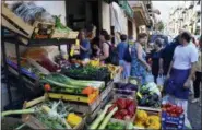  ?? CAIN BURDEAU VIA AP ?? A street scene outside a fruit and vegetable shop in Castelbuon­o, a lively medieval town in the Madonie Mountains in northern Sicily.