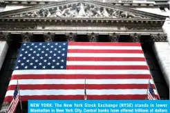  ??  ?? NEW YORK: The New York Stock Exchange (NYSE) stands in lower Manhattan in New York City. Central banks have offered trillions of dollars of support to markets to keep them from freezing up as investors worried about the economic damage from the coronaviru­s. — AFP