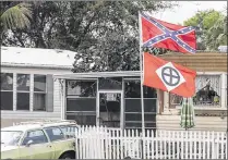  ??  ?? Confederat­e and Ku Klux Klan flags fly at a home near Mike Bagenstos’ on Friday. Since they are not campaign signs, they are not required to be removed, the county code enforcemen­t director says.