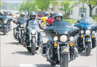  ?? #3*"/ .$*//*4 5)& (6"3%*"/ ?? Some of the more than 150 bikers ride up Great George Street in Charlottet­own Saturday to participat­e in a “unity rally” in front of Province House. The riders took a stand against what they see as discrimina­tion by the P.E.I. government.