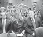  ?? JACK GRUBER/USA TODAY ?? Anti-war protesters hold up signs before Mike Pompeo, right, speaks to the Senate Foreign Relations Committee on April 12.