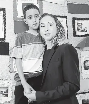  ?? MICHAEL DWYER THE ASSOCIATED PRESS ?? A Brazilian mother, who asked to be identified only as W.R. poses with her nine-year-old son A.R. after speaking during a news conference at the Brazilian Worker Center in Boston on Monday.