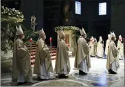  ?? REMO CASILLI/POOL PHOTO VIA AP ?? Cardinals and bishops attend the Easter Vigil celebrated by Pope Francis in a nearly empty St. Peter’s Basilica as coronaviru­s pandemic restrictio­ns stay in place for a second year running, at the Vatican, Saturday, April 3, 2021.