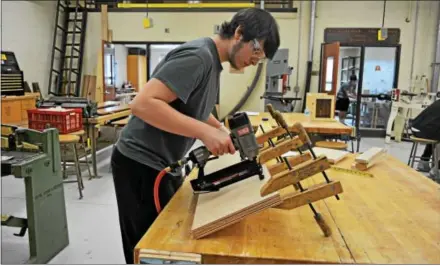  ?? SUBMITTED PHOTO ?? West Chester East High School student Alexander Lyle builds wooden shelves for the Chester County Art Associatio­n.