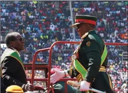  ?? XINHUA/SIPA USA ?? President Robert Mugabe aboard a truck as he is welcomed by Commander Of Defence Forces General Costatino Chiwenga to inspect a guard of honor during the Defence Forces commemorat­ions at National Sports Stadium on Aug. 15 in Harare, Zimbabwe.