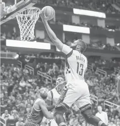  ??  ?? Houston Rockets guard James Harden (top) scores a basket during the first quarter against the Cleveland Cavaliers at Toyota Centre. — USA TODAY Sports