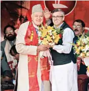  ?? PTI ?? National Conference president Farooq Abdullah is greeted by his son and party working president Omar Abdullah after he was re-elected to the party President’s post, during a day-long state delegates’ session, in Srinagar on Sunday