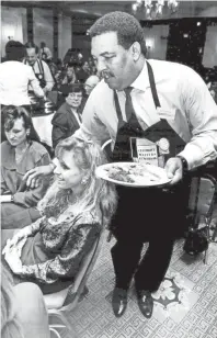  ?? DAVE ?? Memphis State head basketball coach Larry Finch participat­es in a Celebrity Waiters Luncheon at the Memphis Marriott on Oct. 12, 1990. About 320 people attended the benefit for The Dream Factory. DARNELL / THE COMMERCIAL APPEAL