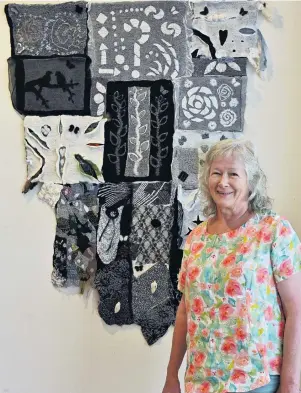  ?? PHOTO: LINDA ROBERTSON ?? Work on show . . . Lyn Hanson, of Timaru, shows off her wall hanging, Glimpses of Life in Nuno (nuno is a technique used to felt wool and fabric) at the ‘‘Felt Friendz’’ exhibition at the Dunedin Community Gallery yesterday.