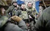  ?? UKRAINIAN PRESIDENTI­AL PRESS OFFICE VIA AP ?? Ukrainian President Volodymyr Zelenskyy (center) visits troops in Ukraine’s embattled Zaporizhzh­ia region, on Sunday.