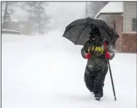  ?? (Arkansas Democrat-Gazette/Stephen Swofford) ?? Pete Dotson uses a pole to help him find the sidewalk and avoid any unexpected deep spots as he walks through the snow last week in Little Rock.