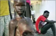  ?? SAM MEDNICK — THE ASSOCIATED PRESS ?? In this photo taken Thursday a boy comes out of the water after going for a swim in the Nile in Akobo town, one of the last rebel-held stronghold­s in South Sudan. Child abductions have risen during South Sudan’s civil war as desperate people try to...